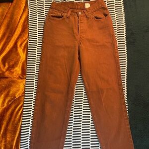 Vintage early ‘90s Levi’s 501 high-waisted rust brown jeans.